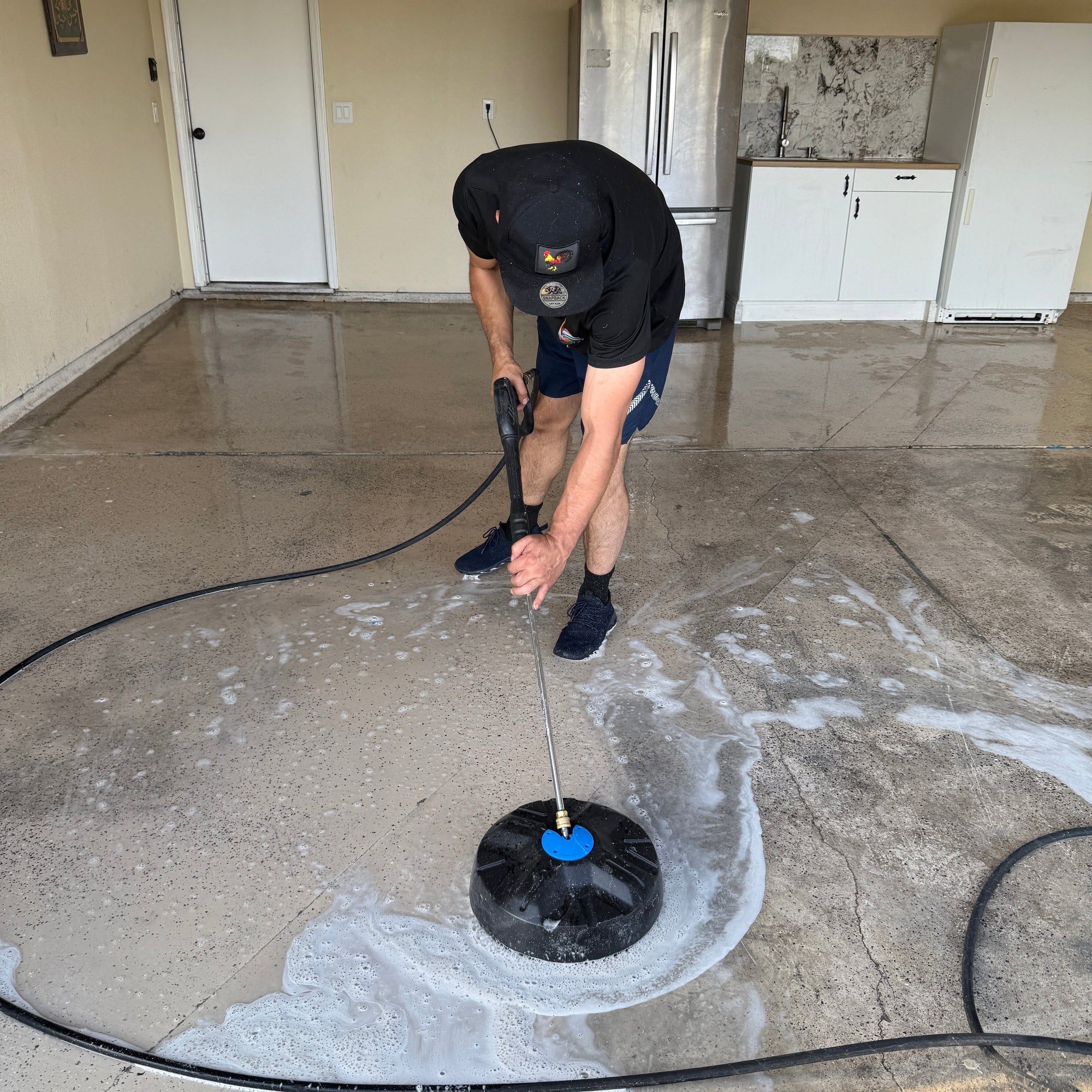 Professional window cleaner using a water-fed pole on a residential window in Yuba City